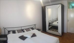 a bedroom with a bed and a large mirror at Full View in Mostar +29 photos