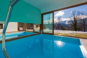 a swimming pool in a house with a view at Dolina in Moravice