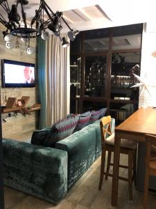 エストサドクにある36 Smart Studio MonteRosaのリビングルーム(緑のソファ、テーブル付)
