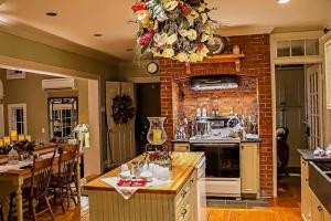 a kitchen with a brick wall with a chandelier at Briarwood Bed & Breakfast in Elmsdale