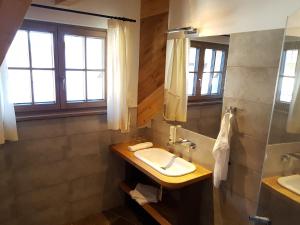 
a bathroom with a sink, toilet, and bathtub at Hotel Vandot in Kranjska Gora

