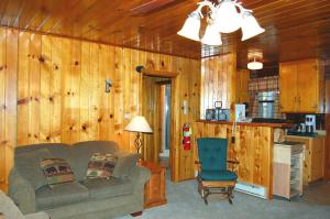 a living room with a couch and a chair at 35 Cubbys Den in Wawona