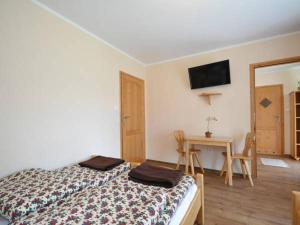 a bedroom with a bed and a table and a mirror at Kamila in Szczawnica