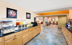 a kitchen with a counter with food on it at Days Inn by Wyndham Fort Dodge in Fort Dodge