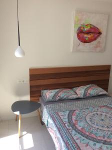 a bedroom with a bed and a table and a painting at Villa Bianco in Orihuela Costa +37 photos