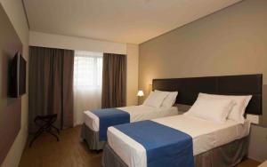 Postel nebo postele na pokoji v ubytování Fity Hotel