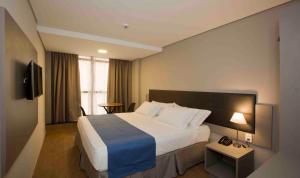 Postel nebo postele na pokoji v ubytování Fity Hotel
