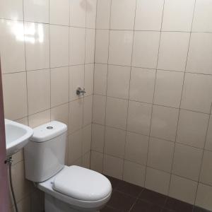 a bathroom with a toilet and a sink at Samudra Beach Chalet in Perhentian Island