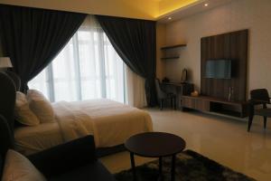 a hotel room with a bed and a television at DingDong Bukit Bintang Luxury Suites,3mi to PaVlion mall in Kuala Lumpur