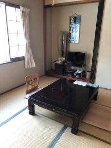 a black ping pong table in a room with a mirror at Shiunso in Nikko