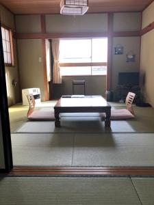 a large room with a table and two chairs at Shiunso in Nikko
