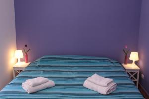 a bedroom with two towels on a bed at Naxos House in Giardini Naxos