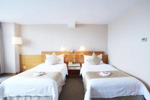 Voodi või voodid majutusasutuse Yihe Hotel Ouzhuang toas