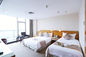 Voodi või voodid majutusasutuse Yihe Hotel Ouzhuang toas