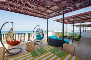 a patio with swings and a table and chairs at Lana Villa in Muscat