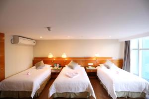 Voodi või voodid majutusasutuse Yihe Hotel Ouzhuang toas