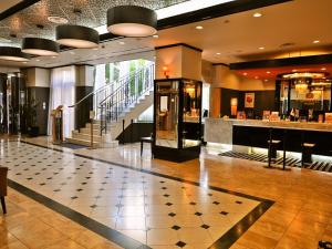 a lobby of a hotel with a counter and stairs at APA Hotel Obihiro Ekimae in Obihiro