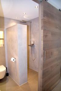 a shower stall in a bathroom with a toilet at Studio-Vrij in Middelburg