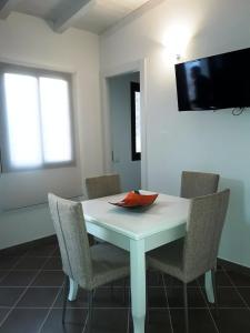 a white dining room table with chairs and a bowl on it at Villa Lucia in Lampedusa