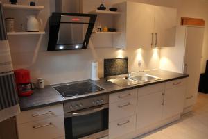 a kitchen with a sink and a microwave at FW "Quendorfer See" in Schüttorf
