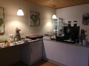 a kitchen with a counter with food on it at Pension Sonneneck in Zwiesel