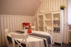 a dining room with a table with flowers on it at Apartment Elena in Bad Wörishofen
