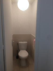 a bathroom with a toilet with a light above it at Inobelle in Béthisy-Saint-Pierre