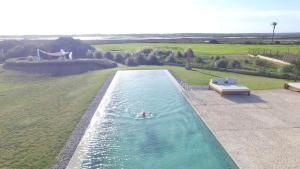 a person swimming in a pool in a field at Fontsanta Hotel Thermal & Spa - Adults Only in Colònia de Sant Jordi