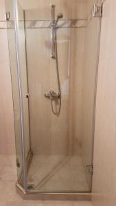 y baño con ducha y puerta de cristal. en Tashevi Apartments, en Pomorie
