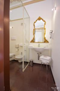 a bathroom with a sink and a toilet and a mirror at B&B Casa Ruffino in Balestrate