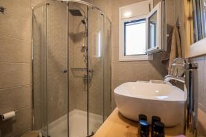 a bathroom with a sink and a glass shower at Stavros Beach Garden Villa in Stavros +35 photos