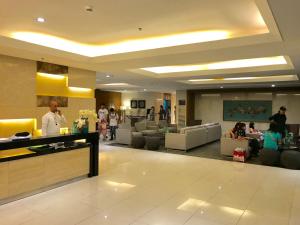 a lobby of a hotel with people sitting on couches at Manila Bay Breeze Residences near MOA and NAIA in Manila +15 photos