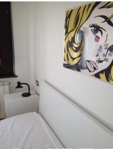 a bedroom with a bed and a painting on the wall at Villa Parco La Collina in Alfedena
