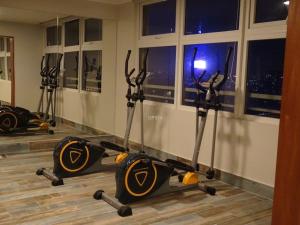 a gym with a row of exercise equipment on the floor at Full Moneda 909 in Santiago