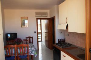 a kitchen and dining room with a stove and a table at S.Maria di Leuca - 30m mare - Salento(Le) in Leuca