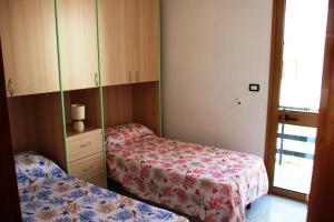 a small room with two beds and a dresser at S.Maria di Leuca - 30m mare - Salento(Le) in Leuca