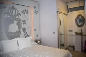 a bedroom with a bed with a picture of a rabbit on the wall at La Princesa y El Guisante in Conil de la Frontera