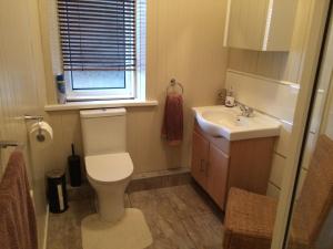 a bathroom with a toilet and a sink and a window at Melrose Guest House in Whitley Bay +19 photos