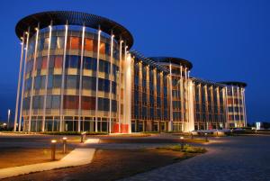 a large building is lit up at night at Hotel Mantova Residence in Mantova