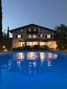 a building with a pool in front of it at La Villa du Parc in Prades