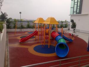 a playground with a slide in a building at Bangi Studio Suite - Netflix in Kampong Sungai Ramal Dalam