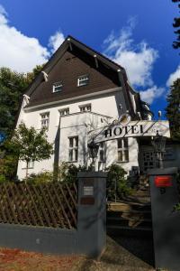 a house with a sign in front of it at Hotel Landhaus Schlachtensee in Berlin