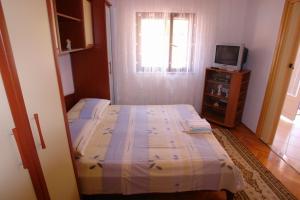 Postel nebo postele na pokoji v ubytování Apartments Leontina