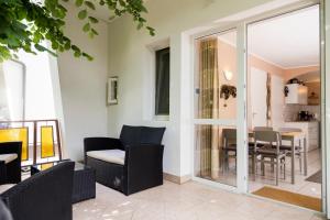 a patio with chairs and a table with a dining room at Vadásztanya Apartmanházak in Siófok +65 photos