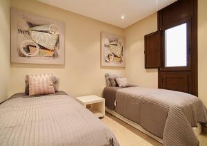 a bedroom with two beds and a window at WaterFront Apartment in Estepona