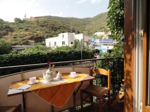 a table and chairs on a balcony with a view at Chiaia Apartments by Caseaponza it in Ponza