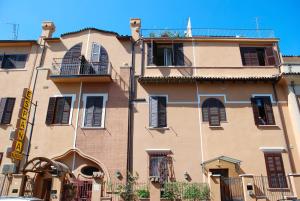 a large building with black shutters on it at Hotel Espana - Gruppo BLAM HOTELS in Rome