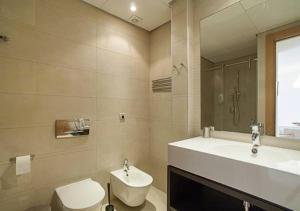 a bathroom with a sink and a toilet and a mirror at Samara Marbella Apartment in Marbella