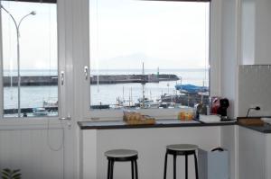 a kitchen with a view of a marina through a window at il Porto Capri Casa Vacanza in Capri