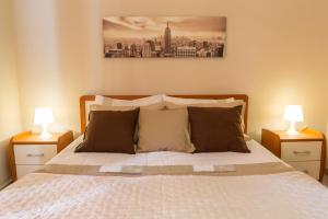 a bedroom with a bed with two nightstands and two lamps at Casa Martina in Giardini Naxos